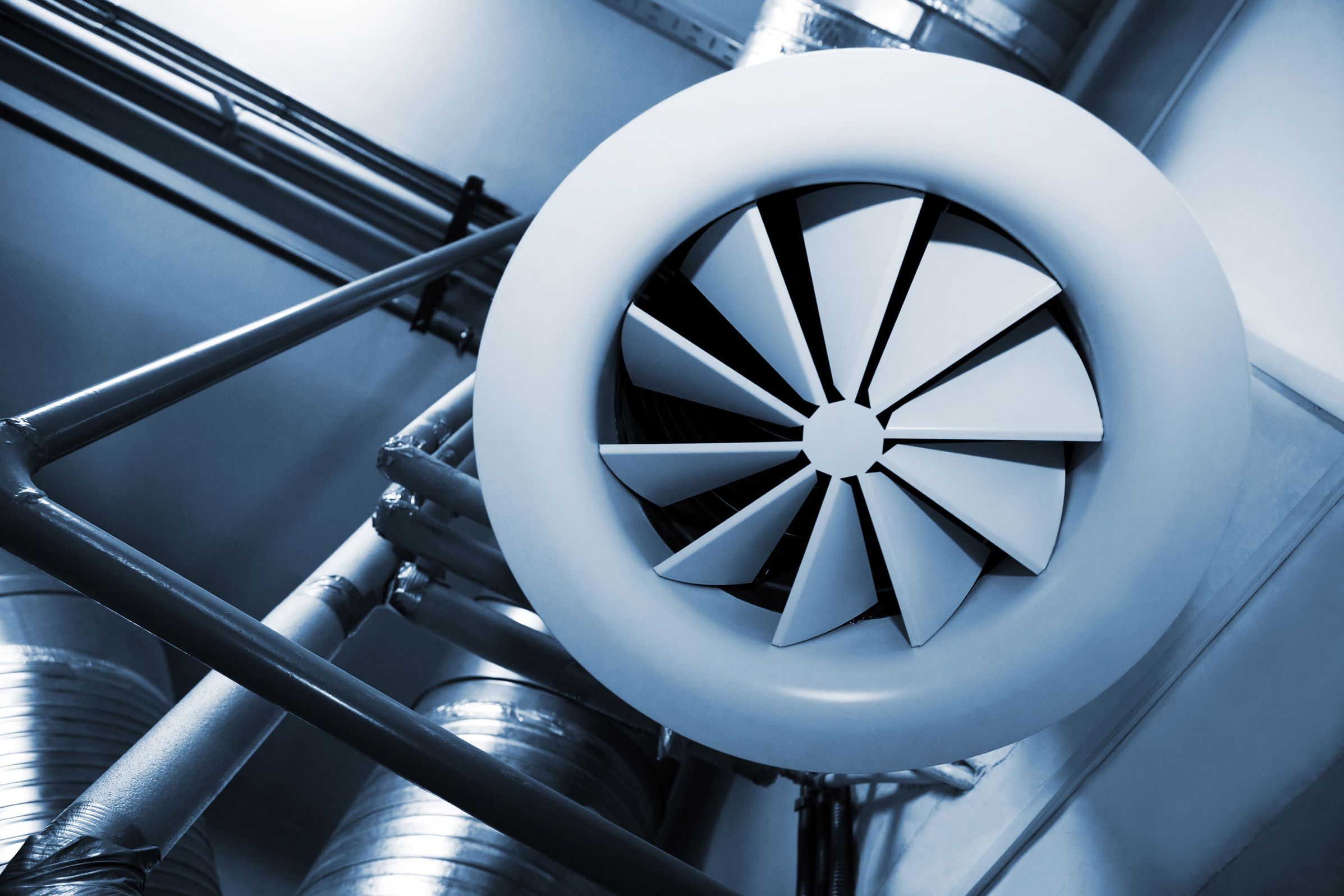 Nahaufnahme eines großen Industrieventilators mit sichtbaren Rotorblättern und robustem Gehäuse.